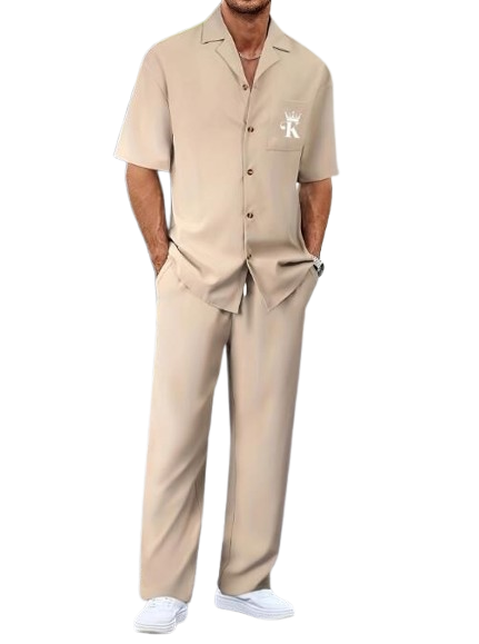 Man wearing beige short-sleeve shirt and matching pants with white shoes.